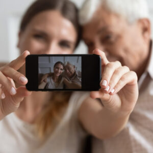 Grandfather and loved one pose for selfie in the best hospice care yonkers ny