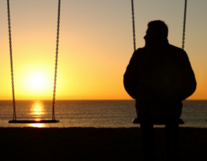 Man sitting on a swing at inpatient hospice in Westchester NY